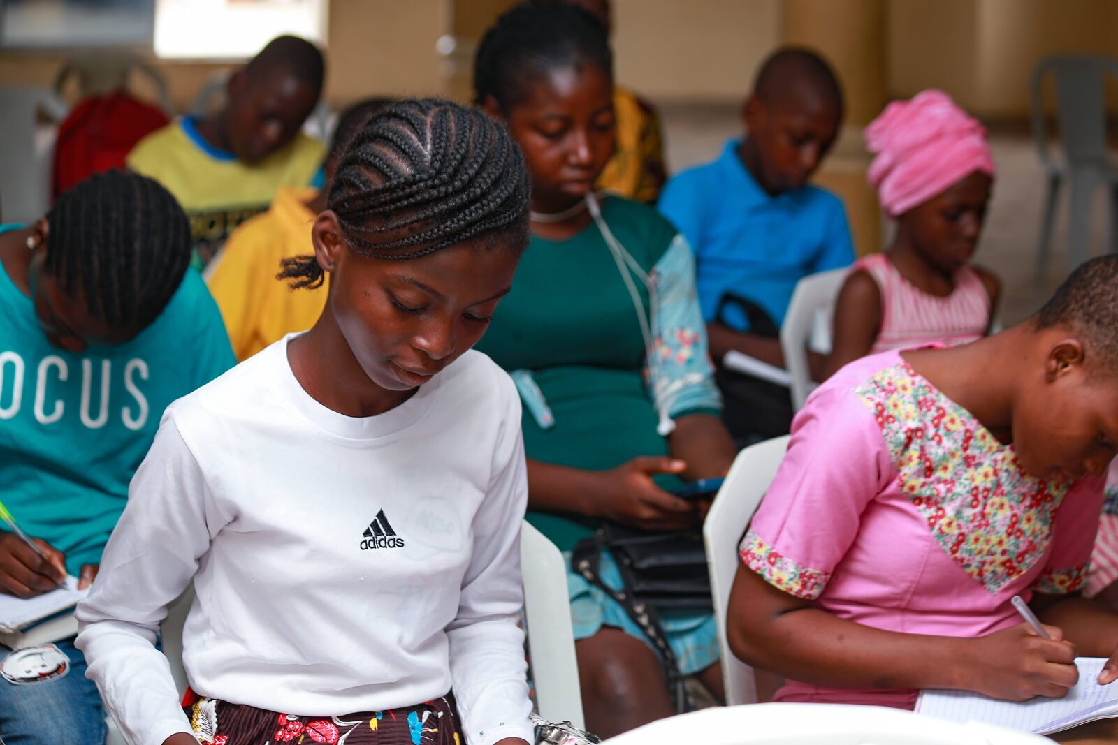 Young people taking notes during a session
