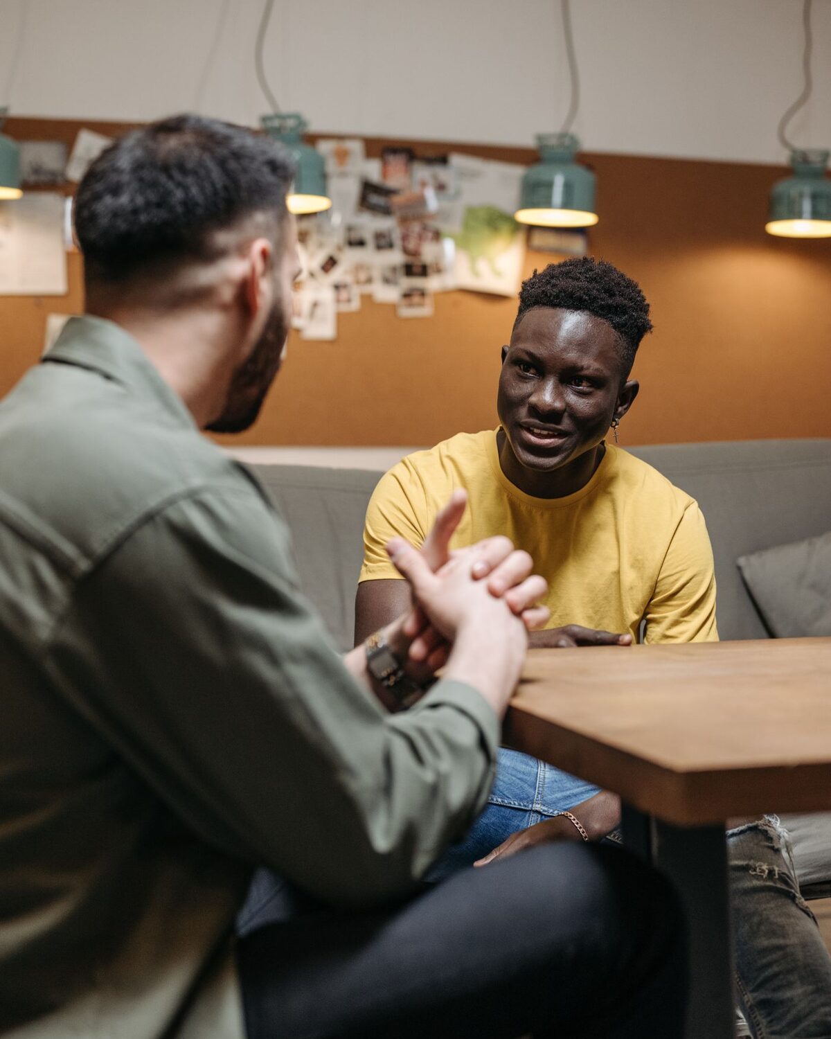 An older and younger person in a mentoring conversation